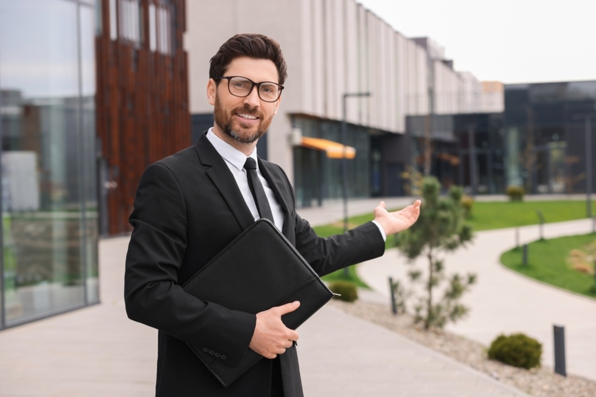 A real estate professional standing in front of buildings