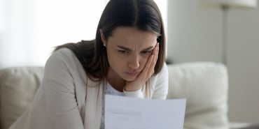  A woman looking at a paper upset 