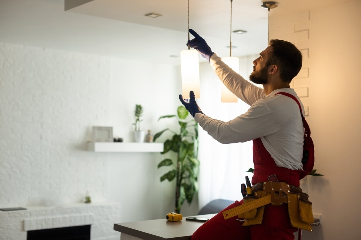 Maintenance repairing lights in an office space