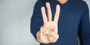  Person holding up 3 fingers 