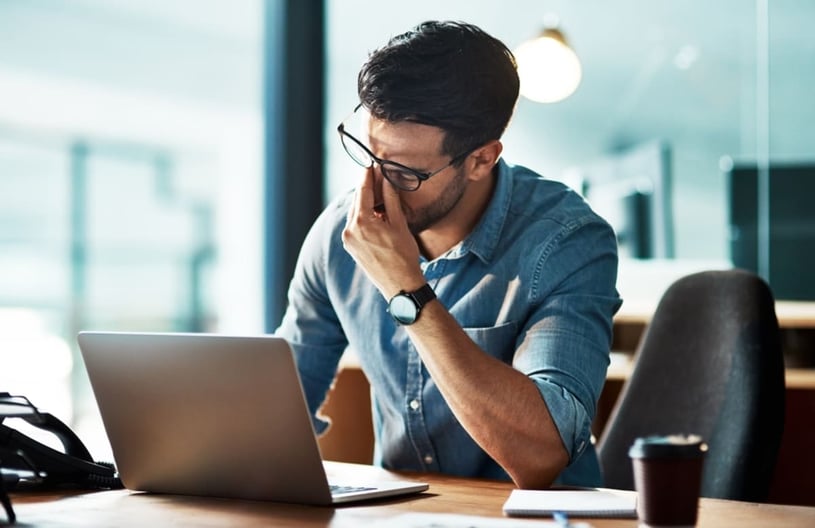 Stressed, tired and frustrated business man with headache at night from burnout