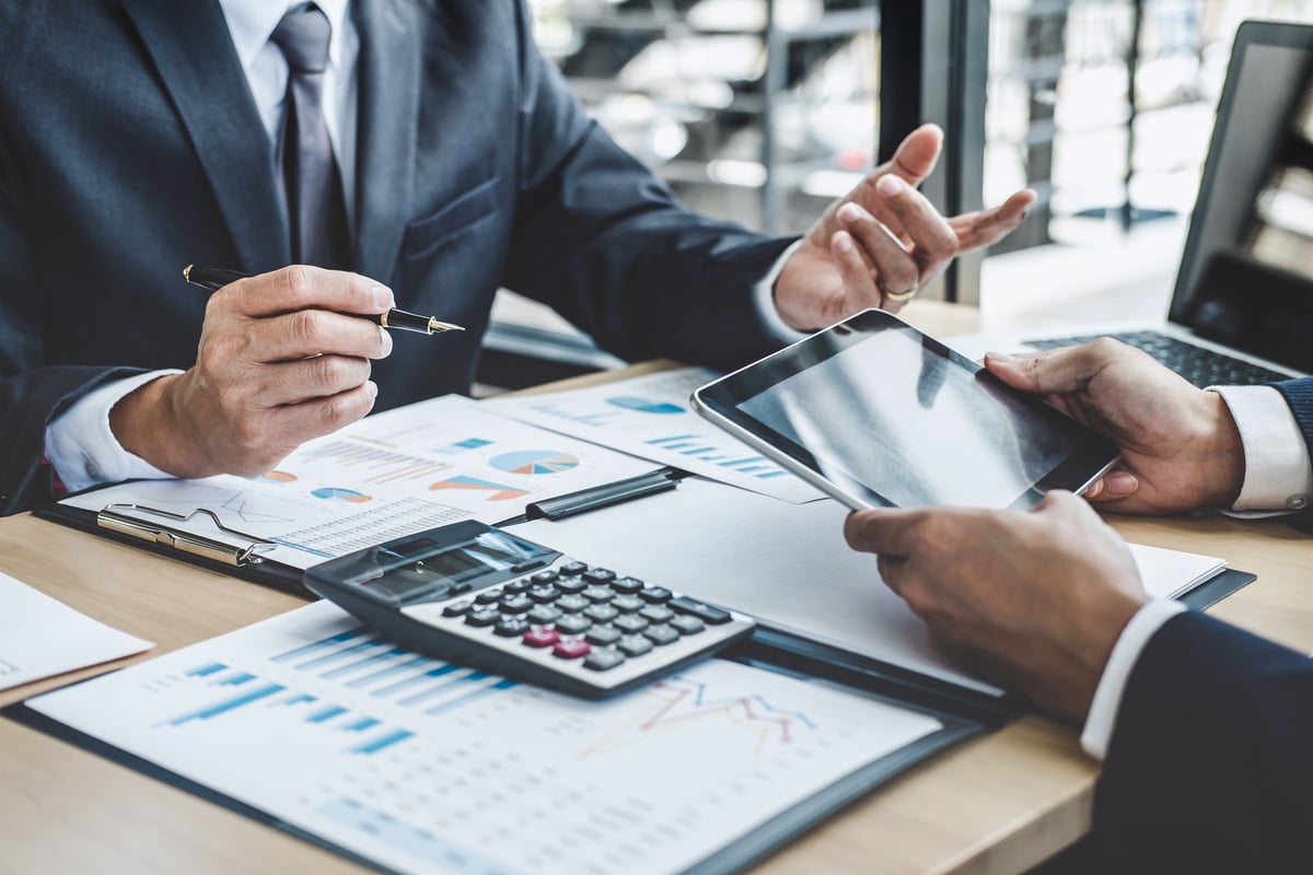 Two businessmen looking at graphs and charts