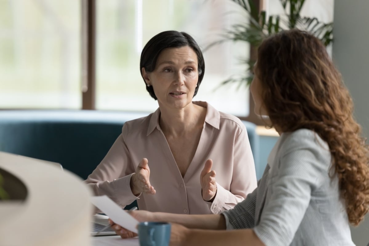 Two people talking in an office setting